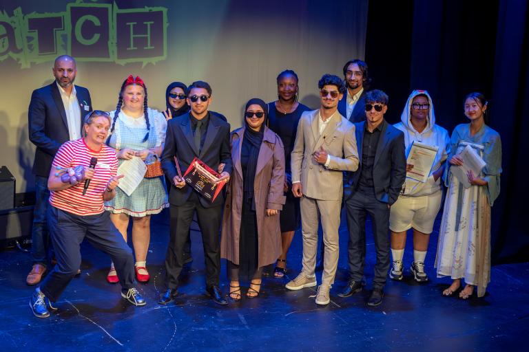 Several people posing at an awards show