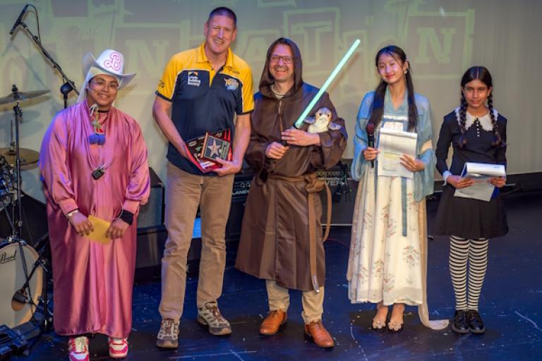 Group of people on stage at an awards show