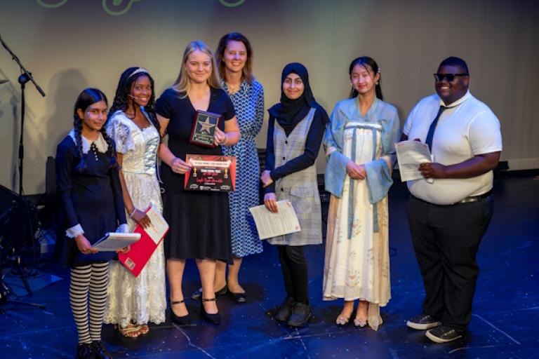 Several people posing at an awards show