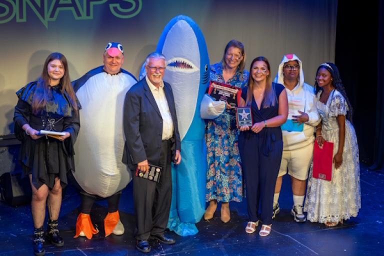 Group of people on stage at an awards show