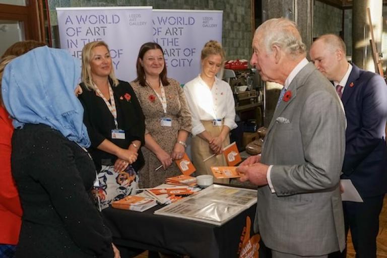 a group of people standing with King Charles