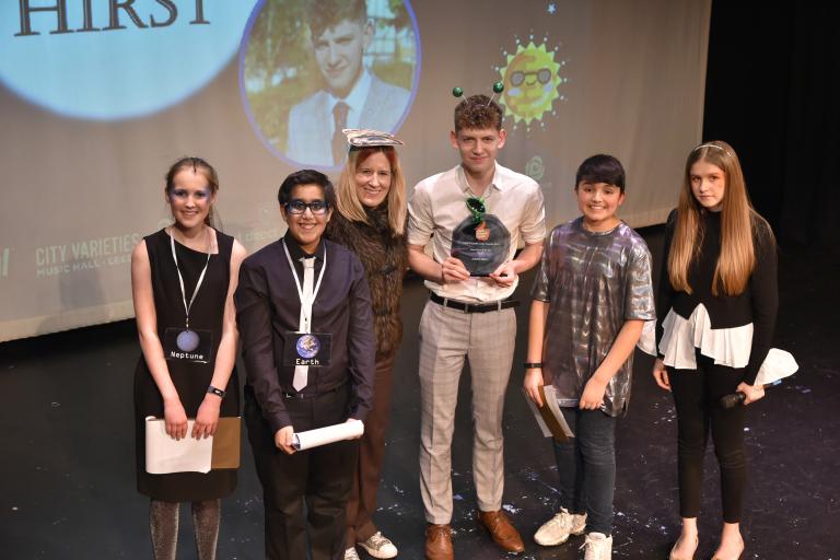 Group of people on stage at an awards show