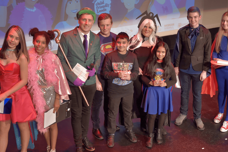 Group of people on stage at an awards show