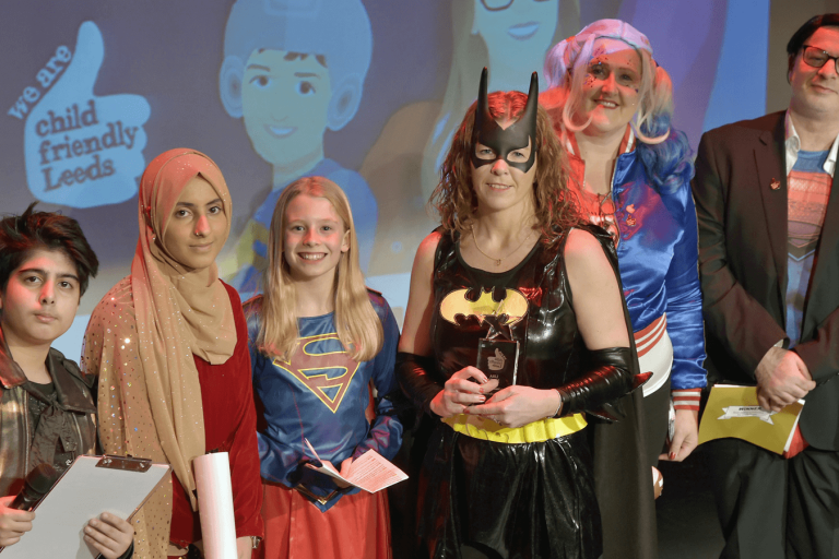 group of people standing on stage at an awards event