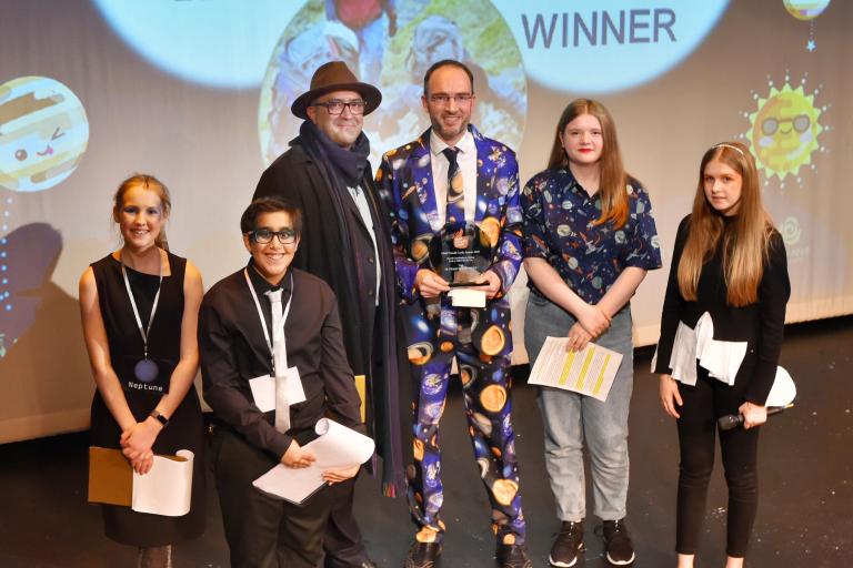 Several people posing at an awards show