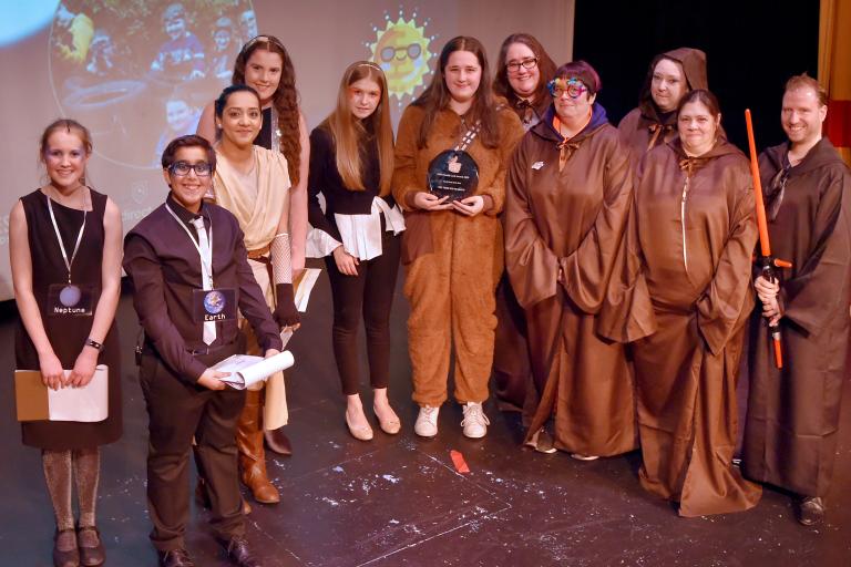 Group of people on stage at an awards show