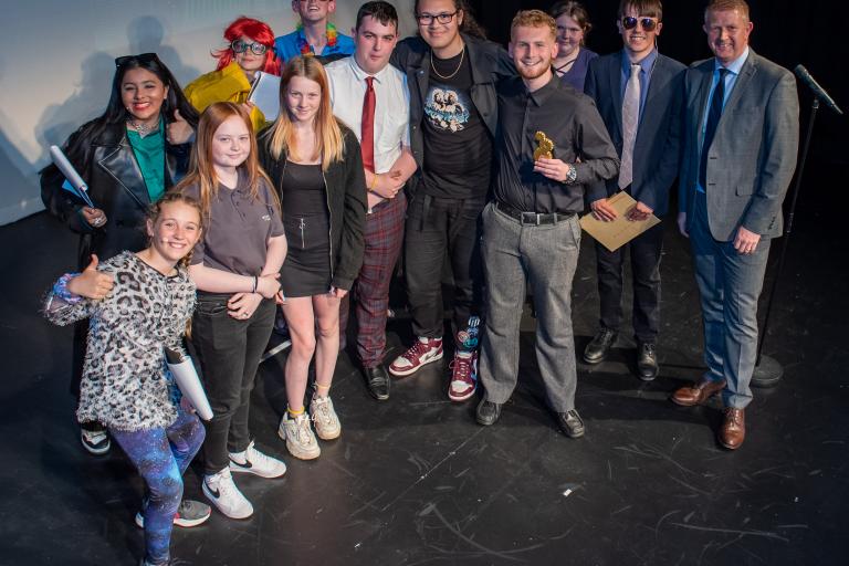 Group of people on stage at an awards show