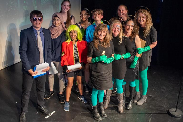 Group of people on stage at an awards show