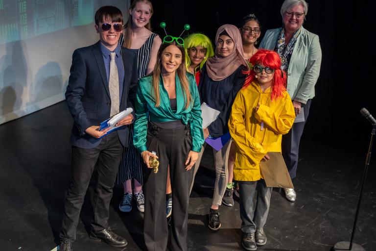 Group of people on stage at an awards show