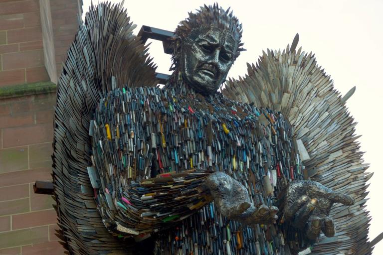 A sculpture of an angel formed from hundreds of metal knives