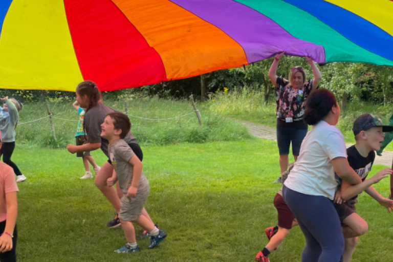 Children playing with a giant parachute