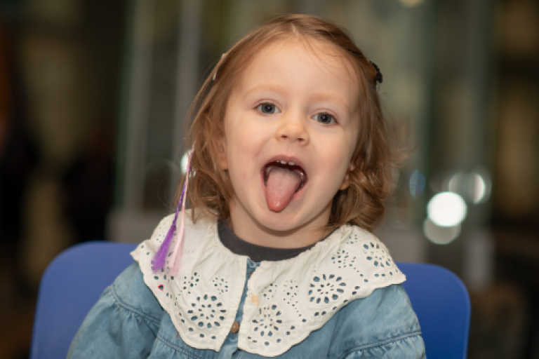 Young child sticking their tongue out