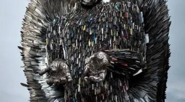 An angel sculpture formed from hundreds of metal knives